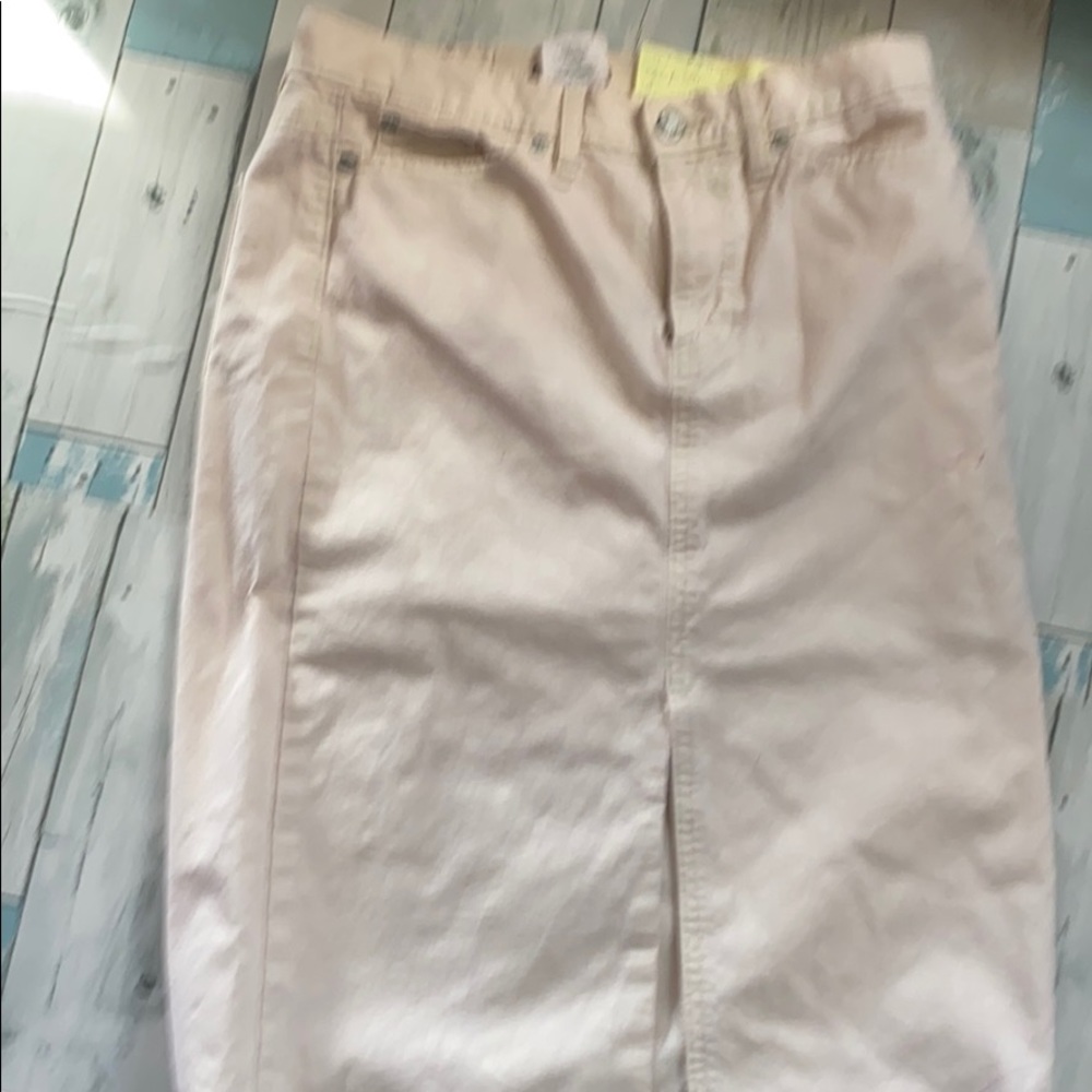 Cream color just above knee length with kick pleat
